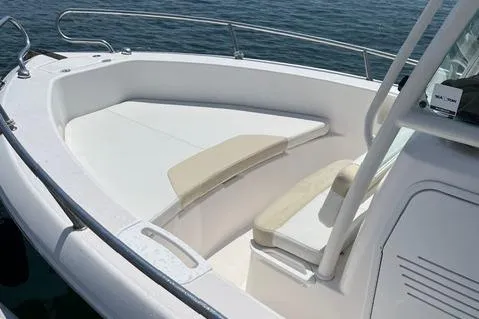 Slide: The Image of 2011 Everglades 230 Center Console boat with white seating and railing on calm water. - 15
