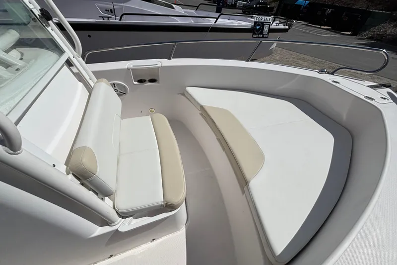 Slide: The Image of 2011 Everglades 230 Center Console boat interior with cushioned seating and cup holders. - 16