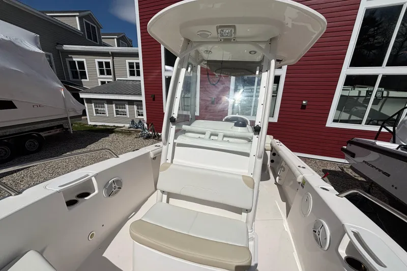 Slide: The Image of 2011 Everglades 230 Center Console boat with seating, docked near red building. - 17