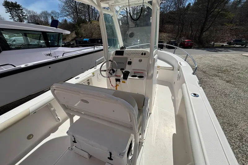 Slide: The Image of 2011 Everglades 230 Center Console boat interior with steering console and seating. - 19