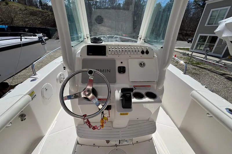 Slide: The Image of 2011 Everglades 230 Center Console boat dashboard with steering wheel and controls. - 20