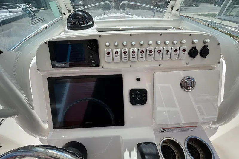 Slide: The Image of Center console of 2011 Everglades 230 boat with navigation instruments and controls. - 22