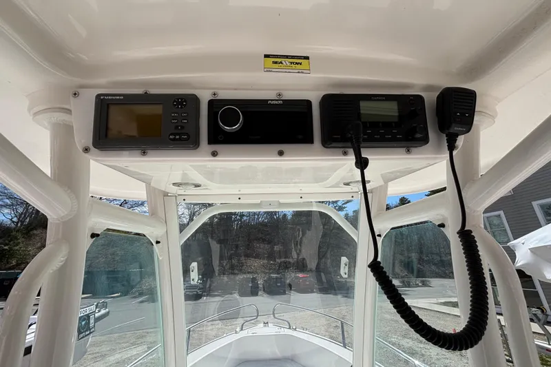 Slide: The Image of 2011 Everglades 230 Center Console boat dashboard with navigation and communication equipment. - 24