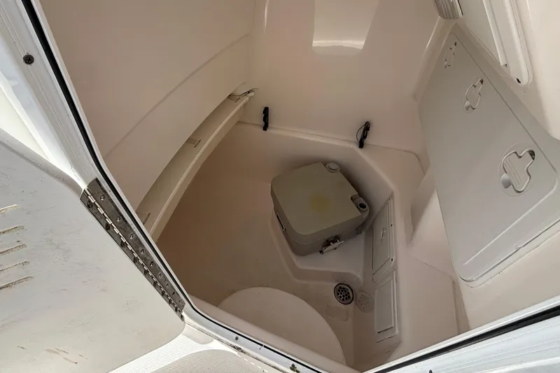 Slide: The Image of Interior of 2011 Everglades 230 Center Console boat with portable toilet. - 25