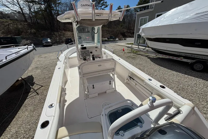 Slide: The Image of 2011 Everglades 230 Center Console boat with Garmin equipment, parked outdoors. - 26