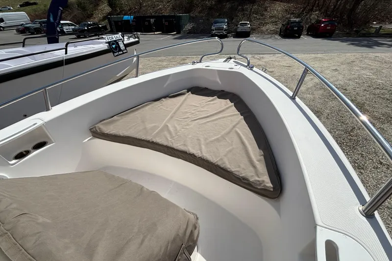 Slide: The Image of Bow seating area of a 2011 Everglades 230 Center Console boat with cushions. - 28