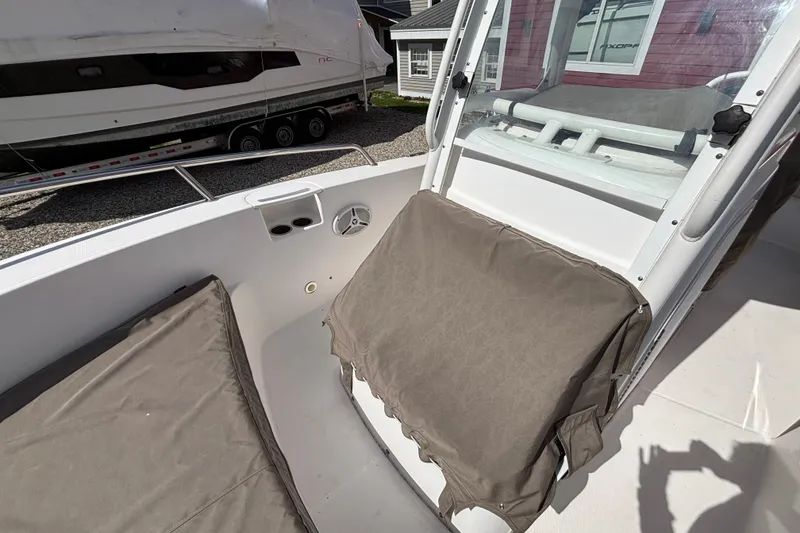 Slide: The Image of 2011 Everglades 230 Center Console boat interior with cushioned seating and console view. - 29