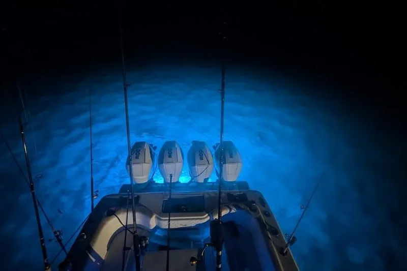 Slide: The Image of 2022 SeaVee 390Z boat with illuminated water and multiple outboard engines at night. - 10