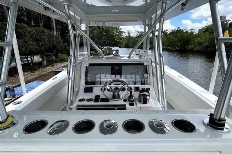 Slide: The Image of 2022 SeaVee 390Z boat cockpit with modern controls and scenic waterway view. - 5
