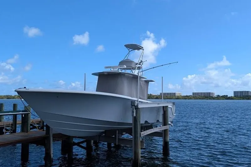 Slide: The Image of 2022 SeaVee 390Z boat docked on a lift, under a clear blue sky. - 9