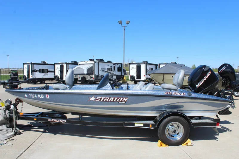 The Image of 2006 Stratos 275 Pro XL boat on trailer, parked outdoors with RVs in background. - 0