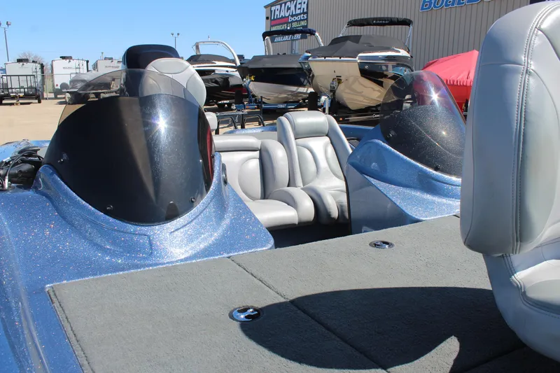 Slide: The Image of 2006 Stratos 275 Pro XL boat with dual windshields and gray seating, displayed outdoors. - 15
