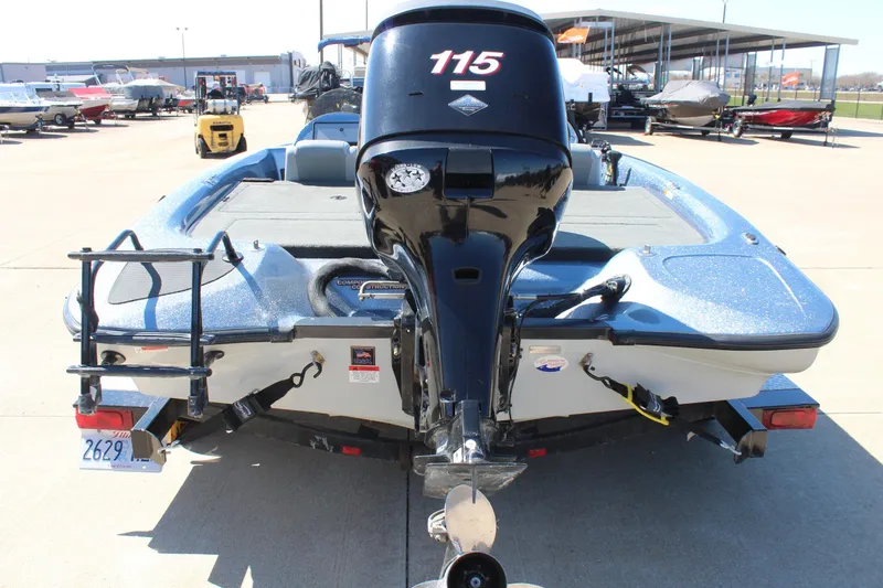 Slide: The Image of 2006 Stratos 275 Pro XL boat with outboard motor, parked in a marina. - 5