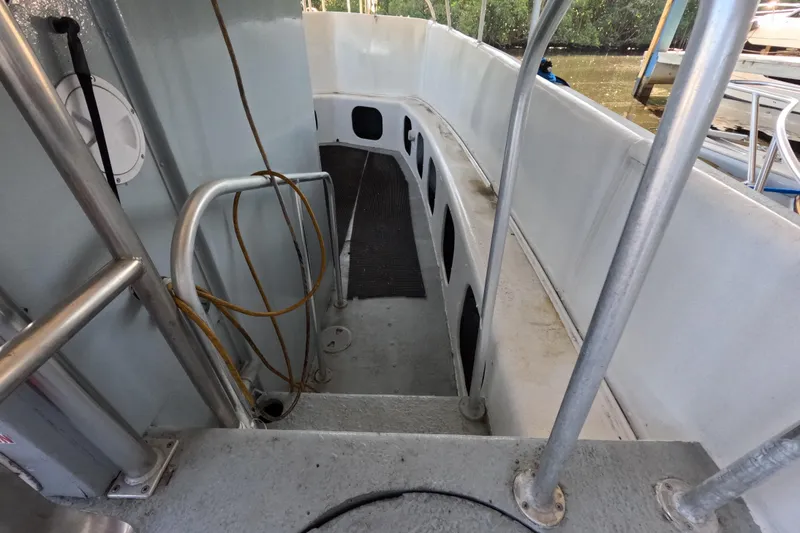 Slide: The Image of Interior view of a 1979 Willard Marine 50 Utility Launch boat with metal railings. - 10