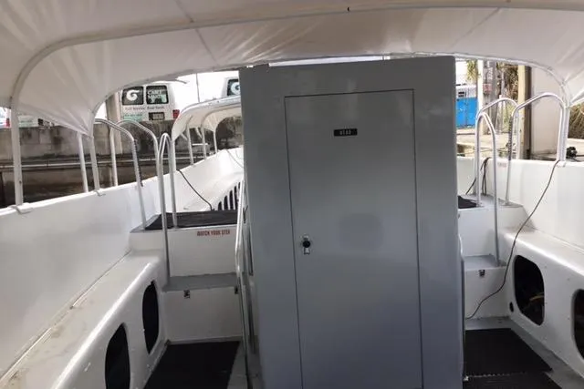 Slide: The Image of 1979 Willard Marine 50 Utility Launch interior with seating and storage compartments. - 12