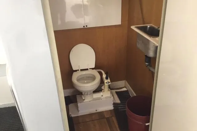 Slide: The Image of Restroom interior of 1979 Willard Marine 50 Utility Launch with toilet and sink. - 14