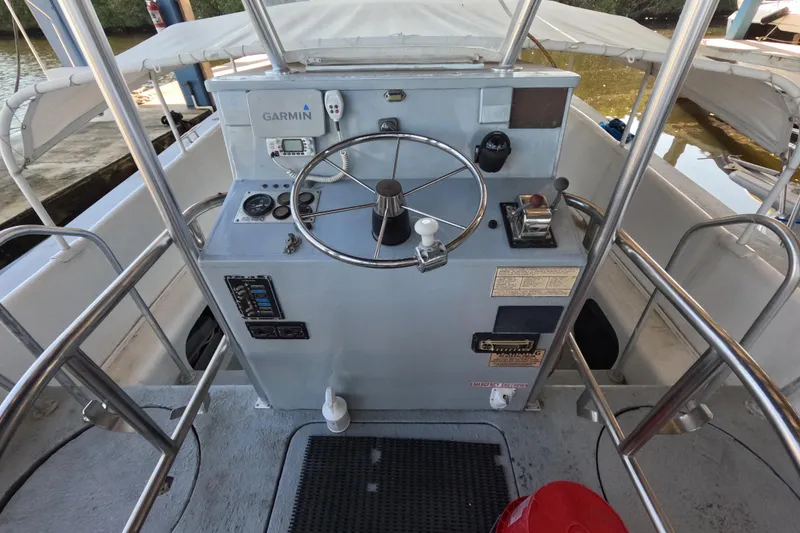 Slide: The Image of 1979 Willard Marine 50 Utility Launch helm with Garmin navigation system and steering wheel. - 2