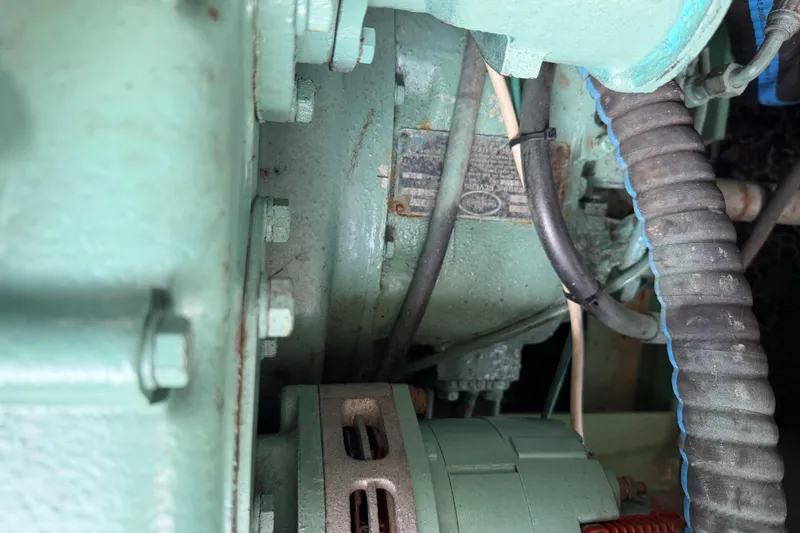 Slide: The Image of Close-up of a 1979 Willard Marine 50 Utility Launch engine components. - 23