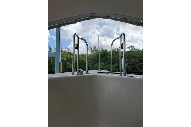 Slide: The Image of View from a 1979 Willard Marine 50 Utility Launch, showcasing railing and lush greenery. - 25