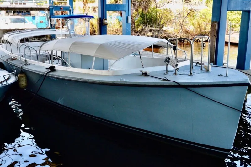 Slide: The Image of 1979 Willard Marine 50 Utility Launch docked under a blue structure. - 27