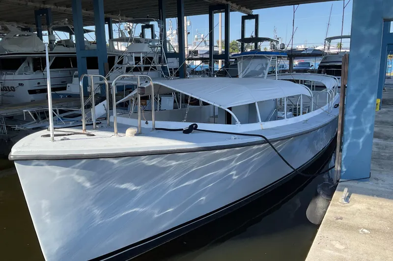 Slide: The Image of 1979 Willard Marine 50 Utility Launch docked in a marina under a covered structure. - 28