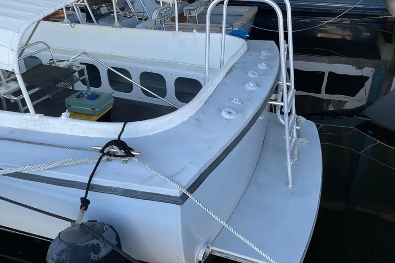 Slide: The Image of 1979 Willard Marine 50 Utility Launch docked, featuring a white deck and metal railings. - 3