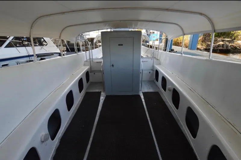 Slide: The Image of Interior view of a 1979 Willard Marine 50 Utility Launch boat, featuring spacious seating. - 6