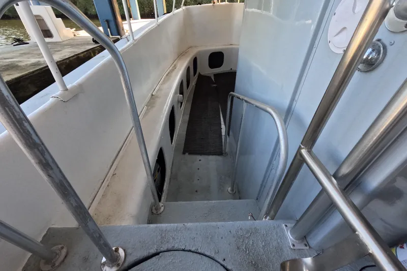 Slide: The Image of Interior view of a 1979 Willard Marine 50 Utility Launch boat with metal railings. - 9