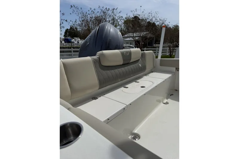 Slide: The Image of 2026 Key West 219 FS boat interior with cushioned seating and storage compartments. - 2