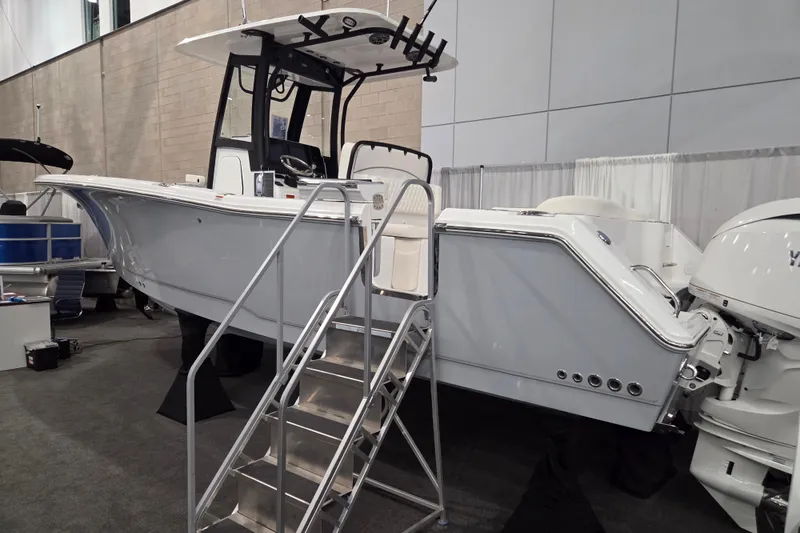 The Image of 2026 Sea Hunt Ultra 275 Coffin Box boat displayed indoors with ladder access. - 0
