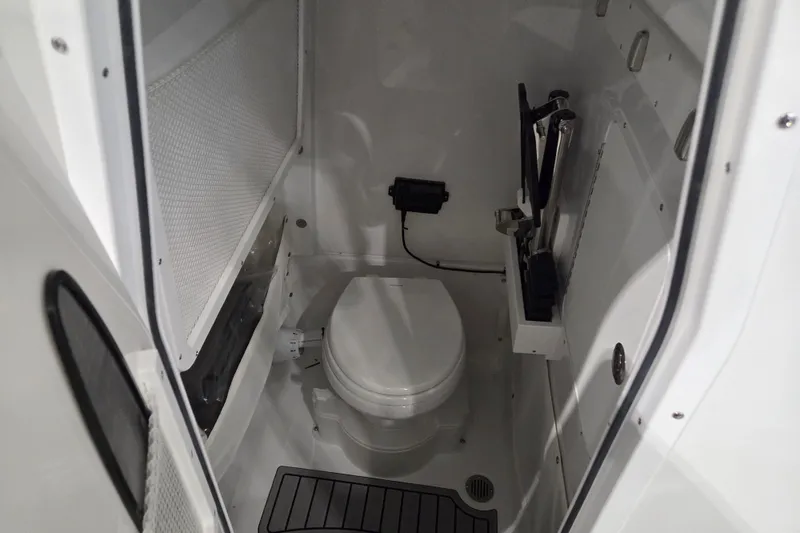 Slide: The Image of Interior of 2026 Sea Hunt Ultra 275 Coffin Box boat bathroom with toilet and storage. - 13