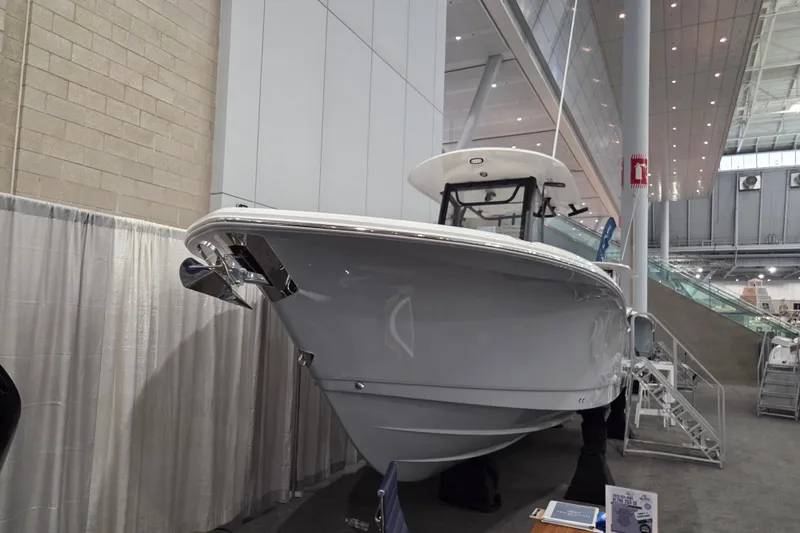 Slide: The Image of 2026 Sea Hunt Ultra 275 Coffin Box boat displayed indoors at an exhibition. - 2