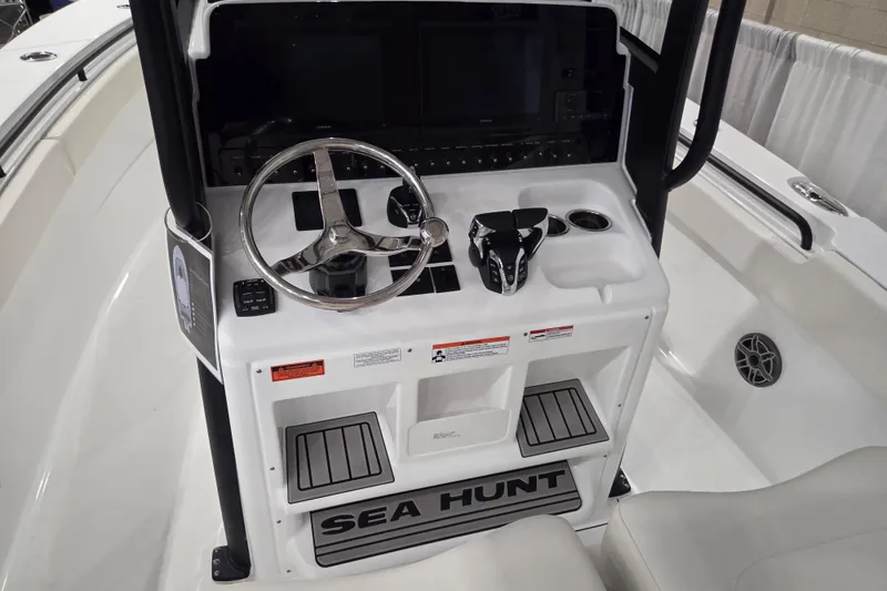 Slide: The Image of 2026 Sea Hunt Ultra 275 Coffin Box boat console with steering wheel and controls. - 3