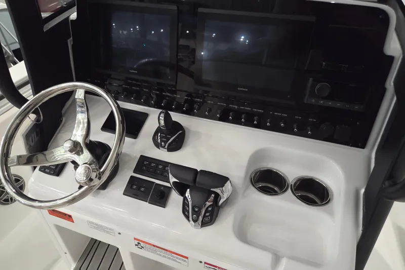 Slide: The Image of Control panel of 2026 Sea Hunt Ultra 275 Coffin Box boat with steering wheel and displays. - 7