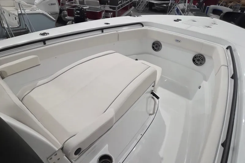 Slide: The Image of 2026 Sea Hunt Ultra 275 Coffin Box boat interior with cushioned seating and speakers. - 9
