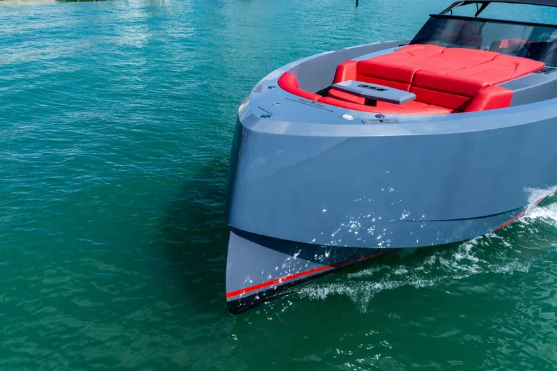 Slide: The Image of 2021 Vanquish Yachts 45 cruising on clear blue water with sleek design and red seating. - 13