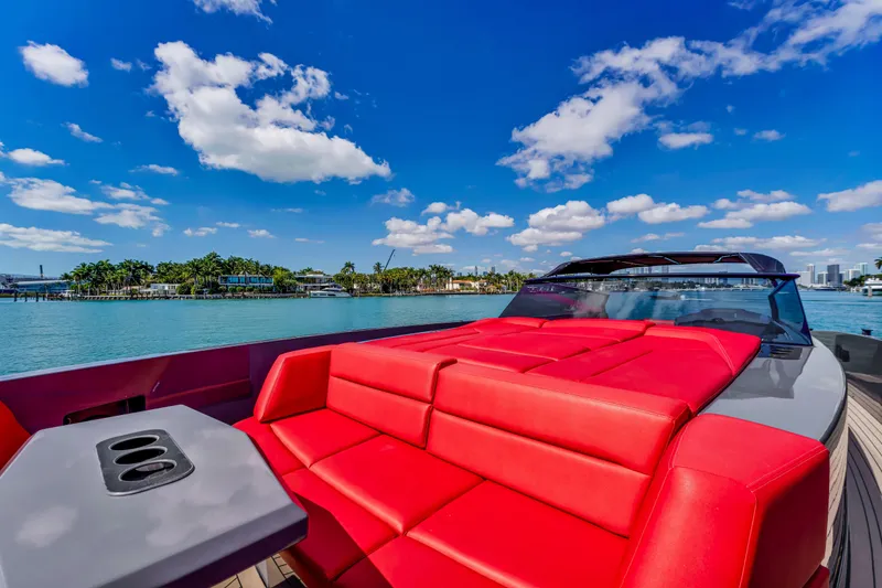 Slide: The Image of Luxurious 2021 Vanquish Yachts 45 with vibrant red seating, cruising on a sunny day. - 16