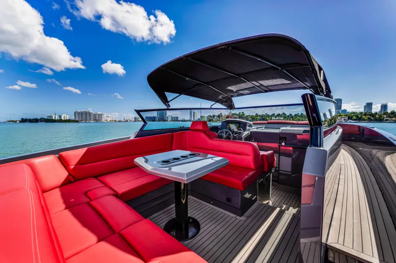 Slide: The Image of Luxurious 2021 Vanquish Yachts 45 with red seating, cruising on a sunny day. - 2