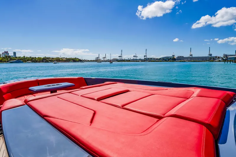 Slide: The Image of 2021 Vanquish Yachts 45 with red sunbed, cruising on a sunny day. - 20