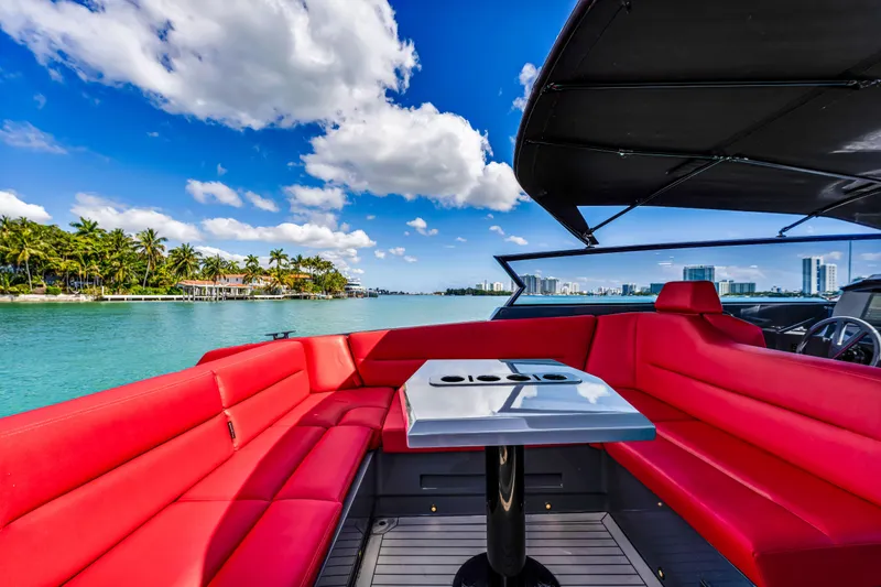 Slide: The Image of Luxurious 2021 Vanquish Yachts 45 with red seating, cruising on a sunny day. - 23