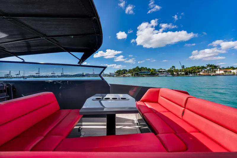 Slide: The Image of Luxurious 2021 Vanquish Yachts 45 with red seating, cruising on a sunny day. - 24