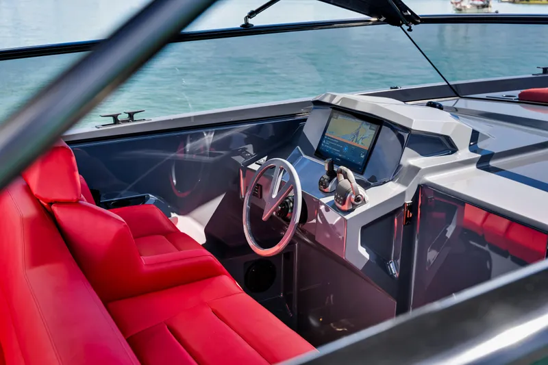 Slide: The Image of Interior of 2021 Vanquish Yachts 45 with red seating and modern dashboard. - 26