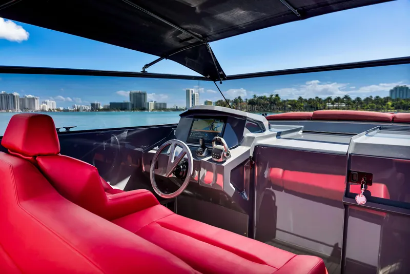 Slide: The Image of Luxurious 2021 Vanquish Yachts 45 interior with red seating and modern dashboard. - 30