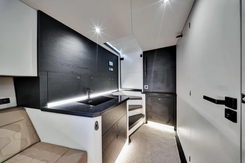 Slide: The Image of Modern interior of 2021 Vanquish Yachts 45, featuring sleek kitchen design and ambient lighting. - 35