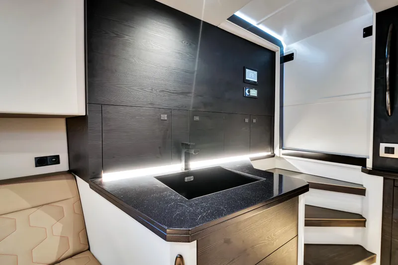 Slide: The Image of Modern interior of 2021 Vanquish Yachts 45 with sleek black sink and ambient lighting. - 36