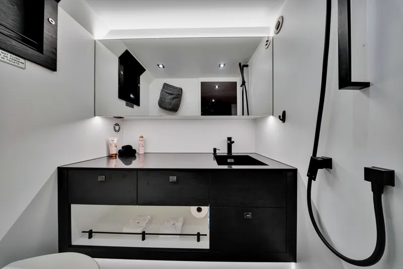 Slide: The Image of Luxurious bathroom interior of 2021 Vanquish Yachts 45, featuring sleek black and white design. - 37