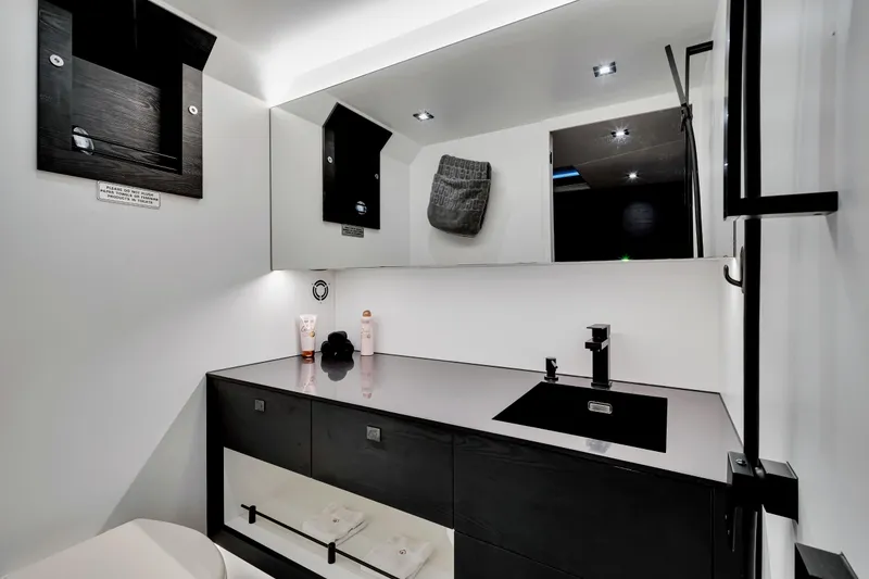 Slide: The Image of Luxurious bathroom interior of 2021 Vanquish Yachts 45, featuring sleek black and white design. - 38