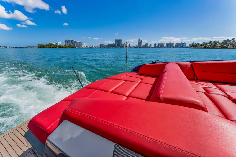 Slide: The Image of Luxurious 2021 Vanquish Yachts 45 with red seating, cruising on a sunny day. - 43