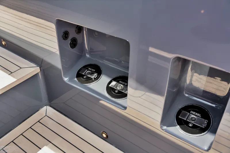 Slide: The Image of Fuel and water access panel on 2021 Vanquish Yachts 45, featuring diesel and waste ports. - 44