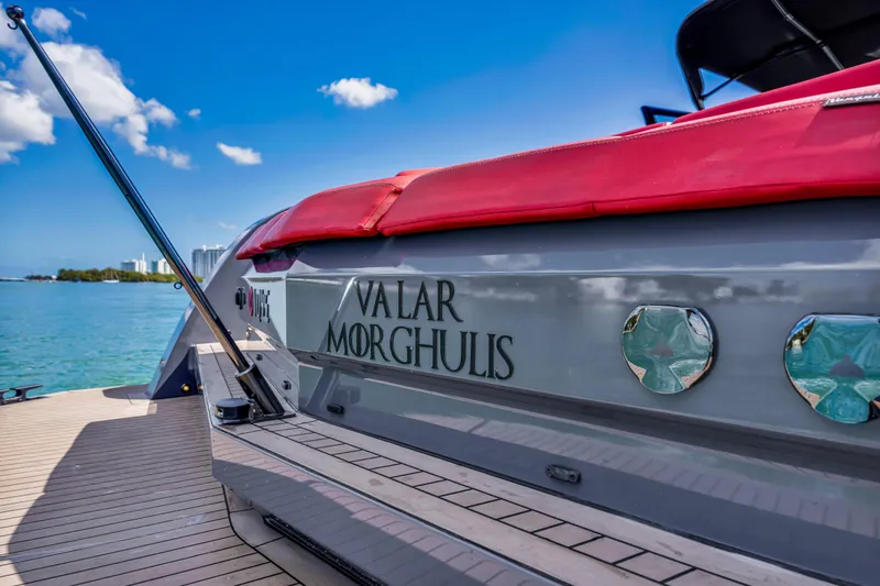 Slide: The Image of Vanquish Yachts 45, 2021 model, with "Valar Morghulis" text, docked by clear blue water. - 45